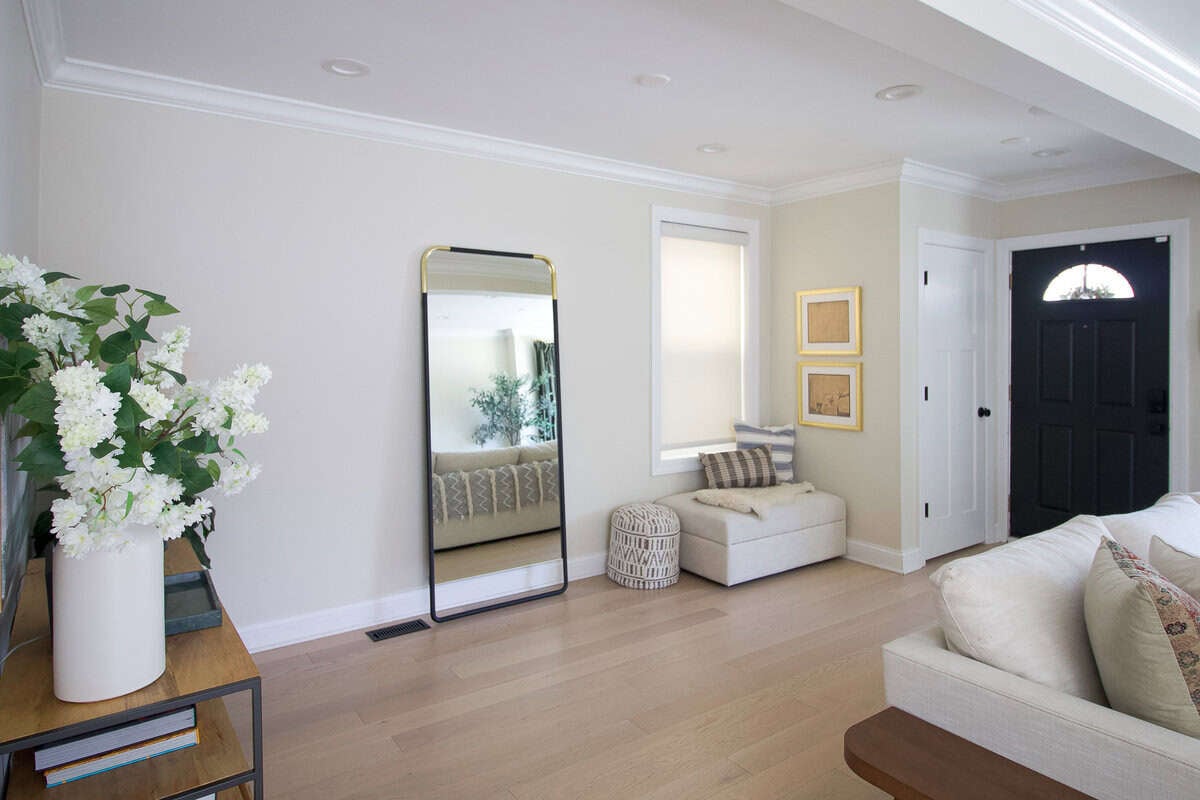 Front entry before: small closet, crowded doorway, underutilized space